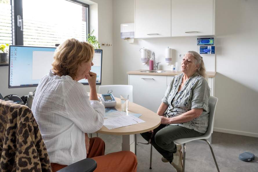 Twee vrouwen in gesprek aan de keukentafel